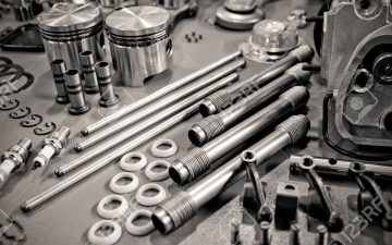 9308201-collection-of-precision-auto-engine-parts-laid-out-in-a-workshop-Stock-Photo