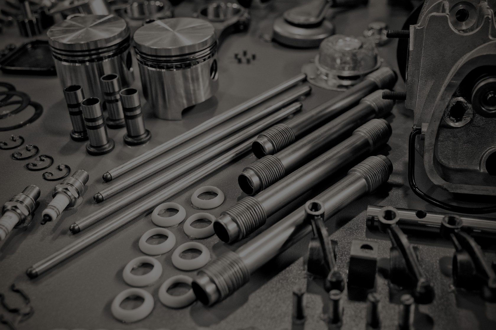 9308201 – collection of precision auto engine parts laid out in a workshop
