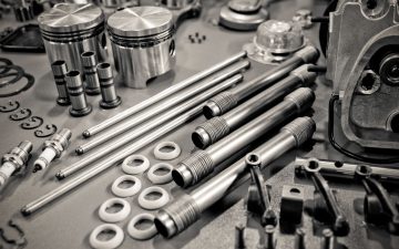 9308201 - collection of precision auto engine parts laid out in a workshop